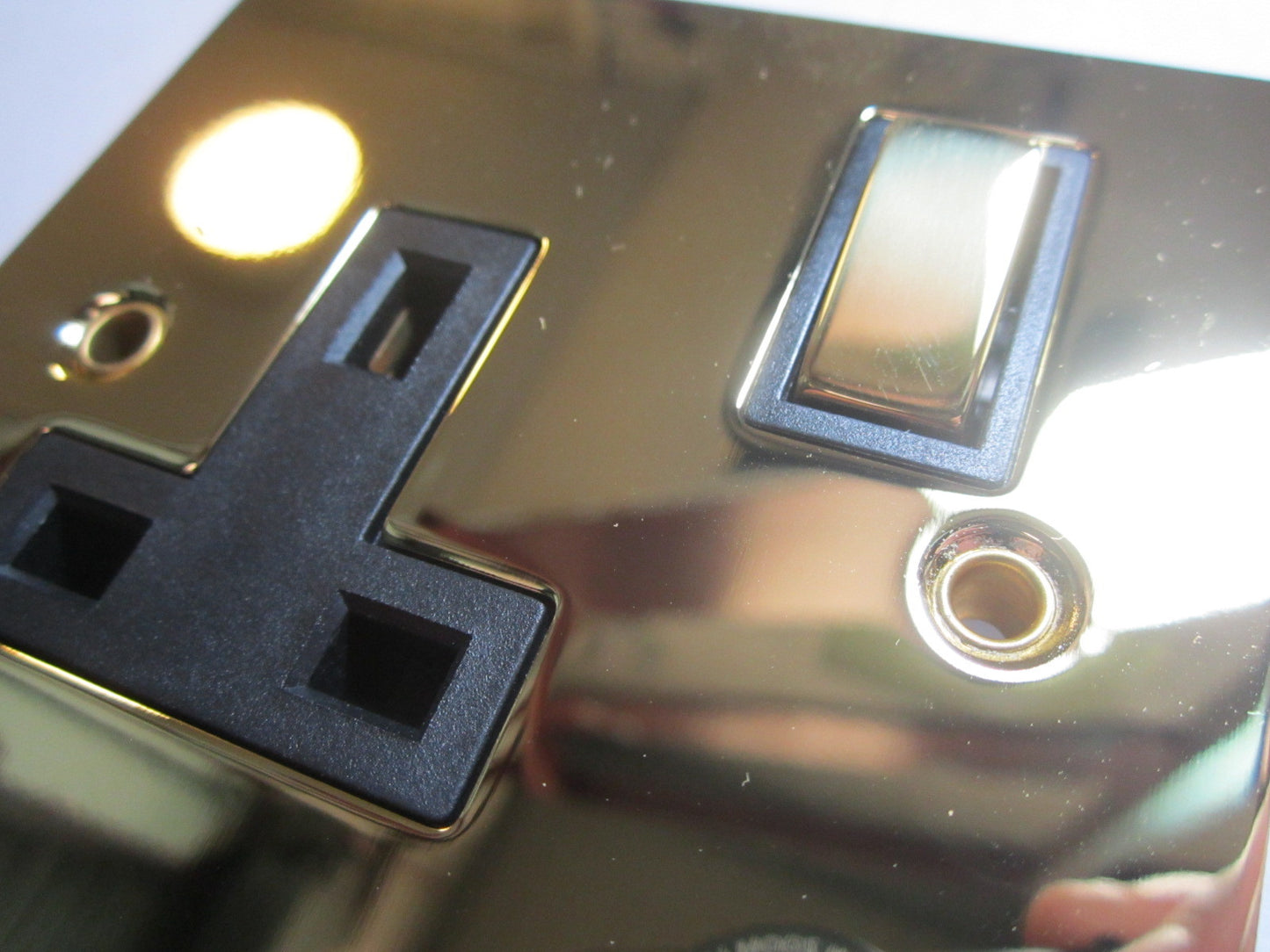 Volex 1 Gang Switched Socket 13A Double Pole Black Interior Polished Brass Flat